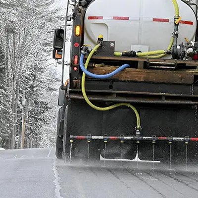 truck applying brine to the road