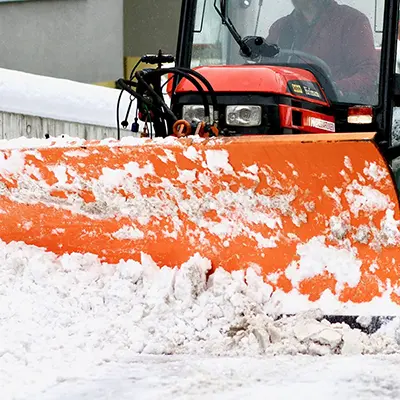 tractor with snow blade, pushing snow