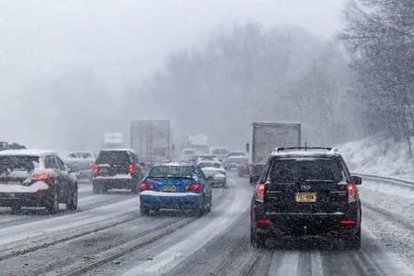 Heavy highway traffic during a snow storm